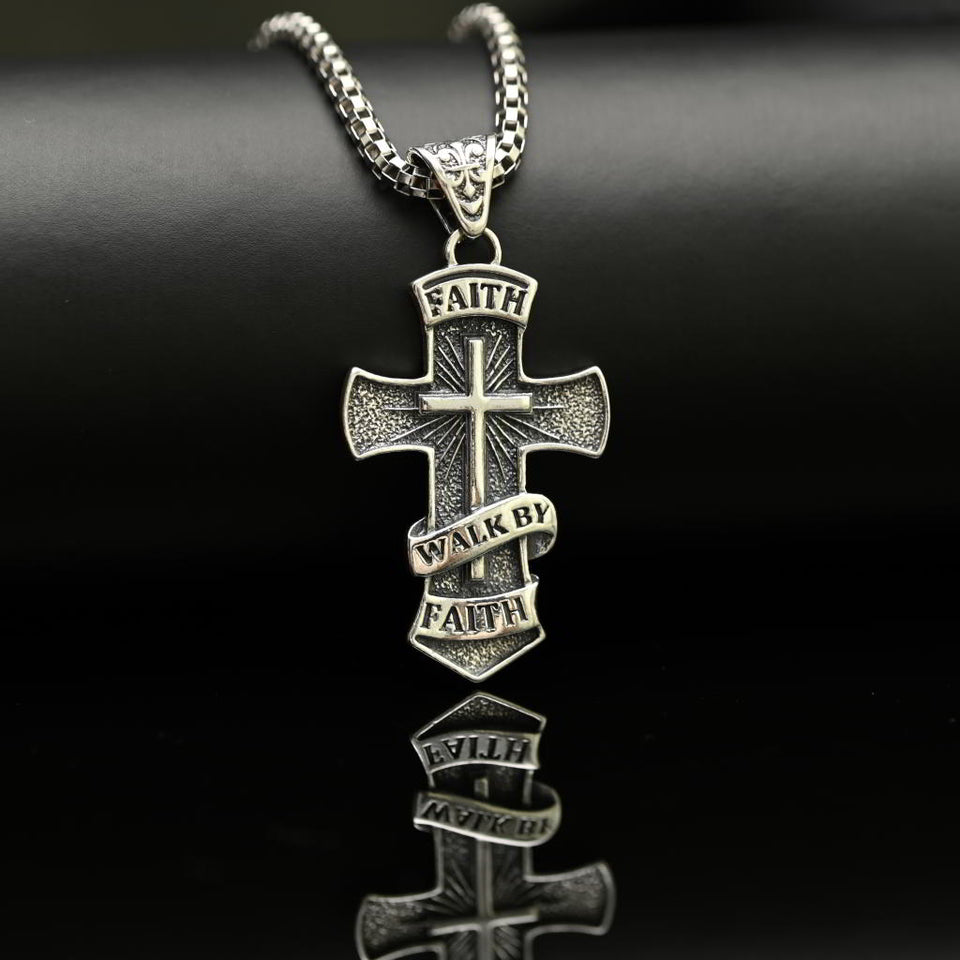 Silver cross pendant with 'Faith Walk by Faith' text on a black background