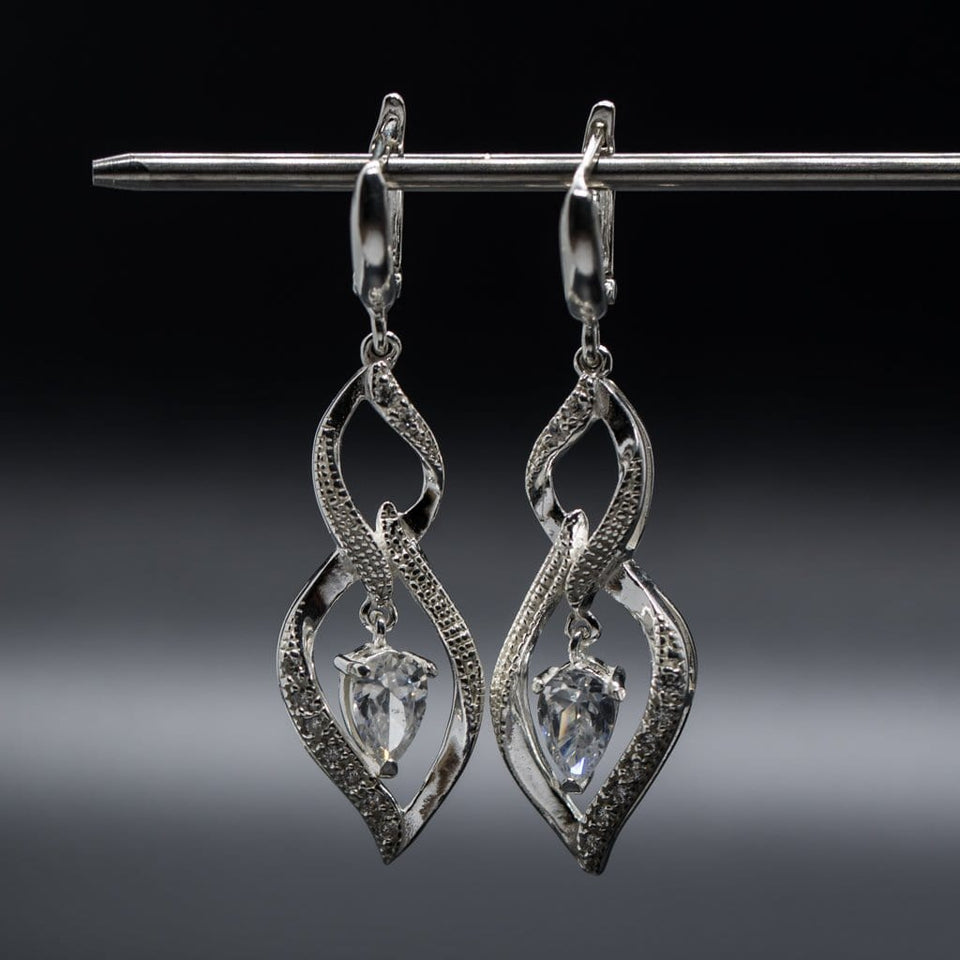 Charm sterling silver 925 jewelry set of stylish dangling and curved pendant, dainty chain necklace and earrings, made with shining zircon stylish design. Elegant silver jewelry female set, made with shining zircon, perfect choice as a fancy gift to your girlfriend, wife, mom, or female friends at Easter, anniversary, engagement, party, meeting, dating, wedding or usual wear. Hypoallergenic sterling silver necklace set, allergy-free. Check out other elegant jewelry for women at silverslegends.com...