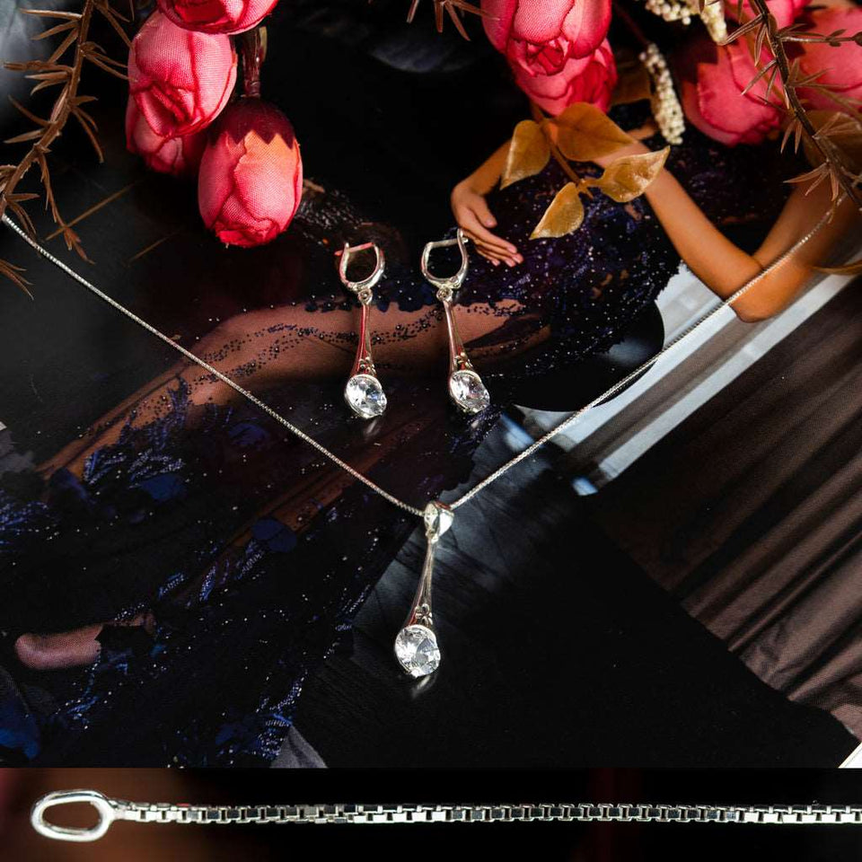 Sterling Silver 925 dangling teardrop-shaped set of pendant, necklace and earrings made with shining light blue zircon stylish design. Elegant silver jewelry female set, made with shining zircon, perfect choice as a fancy gift to your girlfriend, wife, mom, or female friends at Easter, anniversary, engagement, party, meeting, dating, wedding or usual wear. Hypoallergenic sterling silver necklace set, allergy-free. Check out other elegant jewelry for women at silverslegends.com...