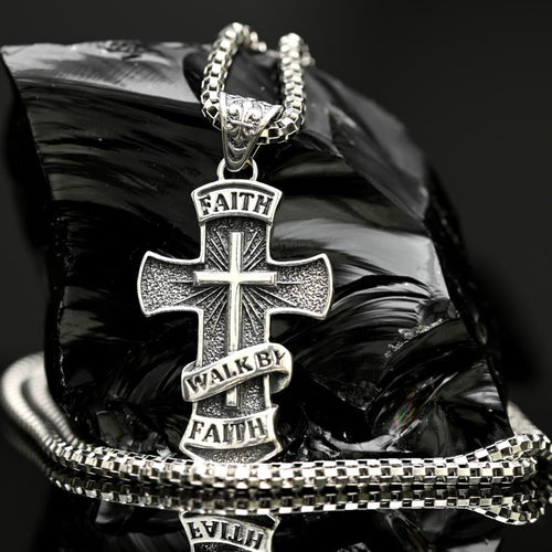 925 sterling silver Walk by Faith cross necklace with 3mm box chain. Silver cross necklace with 'Faith Walk By Faith' text on a reflective surface