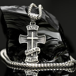 925 sterling silver Walk by Faith cross necklace with 3mm box chain. Silver cross necklace with 'Faith Walk By Faith' text on a reflective surface