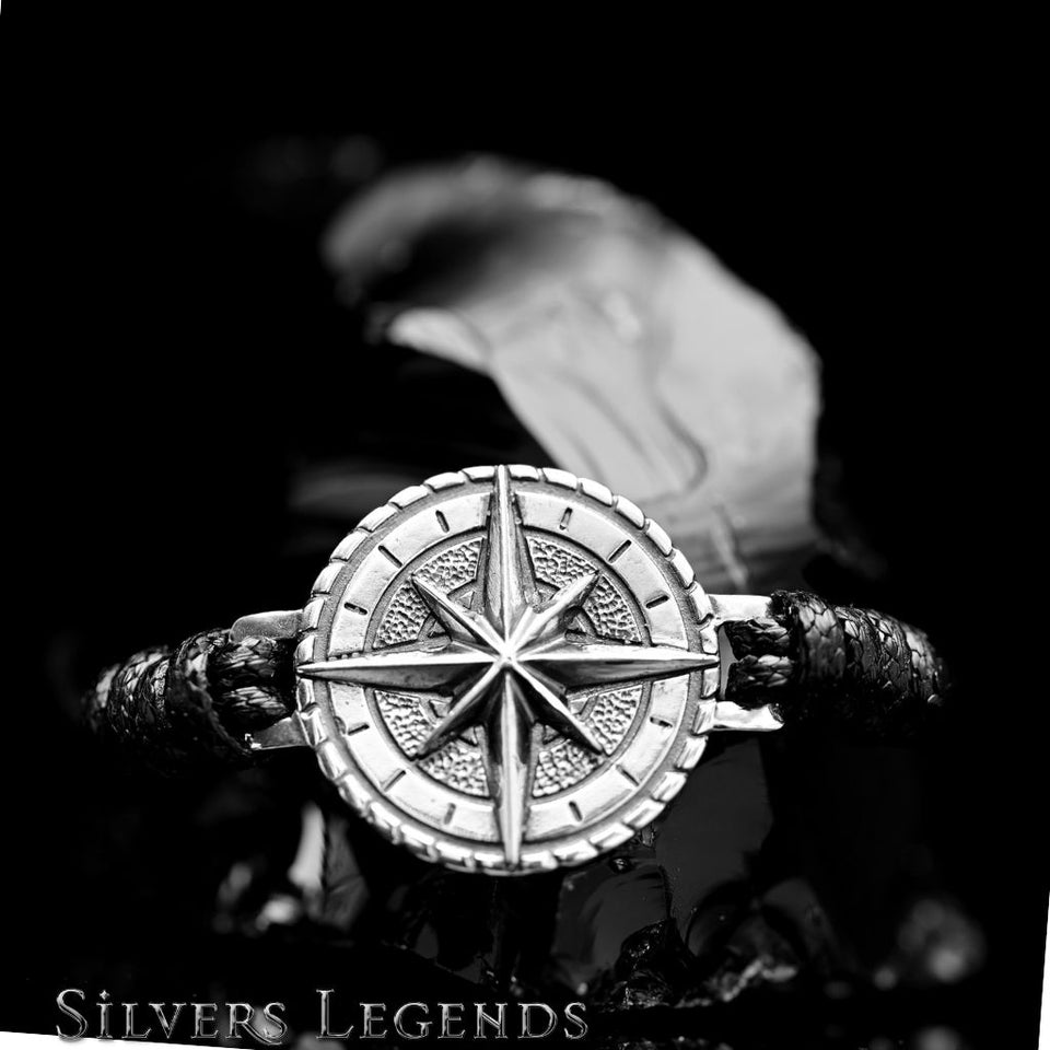 Silver bracelet with star design held by a hand against a dark background, branded 'Silvers Legends'.