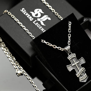 Silver cross necklace with 'Faith' engraving on a black box with 'Silvers Legend' branding.