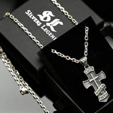 Silver cross necklace with 'Faith' engraving on a black box with 'Silvers Legend' branding.