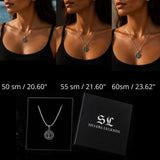 Three models wearing a silver pendant necklace with a circular initial 'M' charm, shown above a product display of the necklace on a chain and its black presentation box with the brand name 'Silvers Legends'.