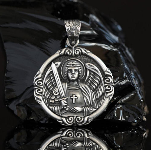 Sterling silver Archangel Michael pendant for men, detailed Catholic miraculous medal with sword and angel wings, handcrafted 925 silver protection medallion. Side view of solid 925 sterling silver Archangel Michael medal, showing intricate engraved details of angel and sword, large men’s religious pendant handmade