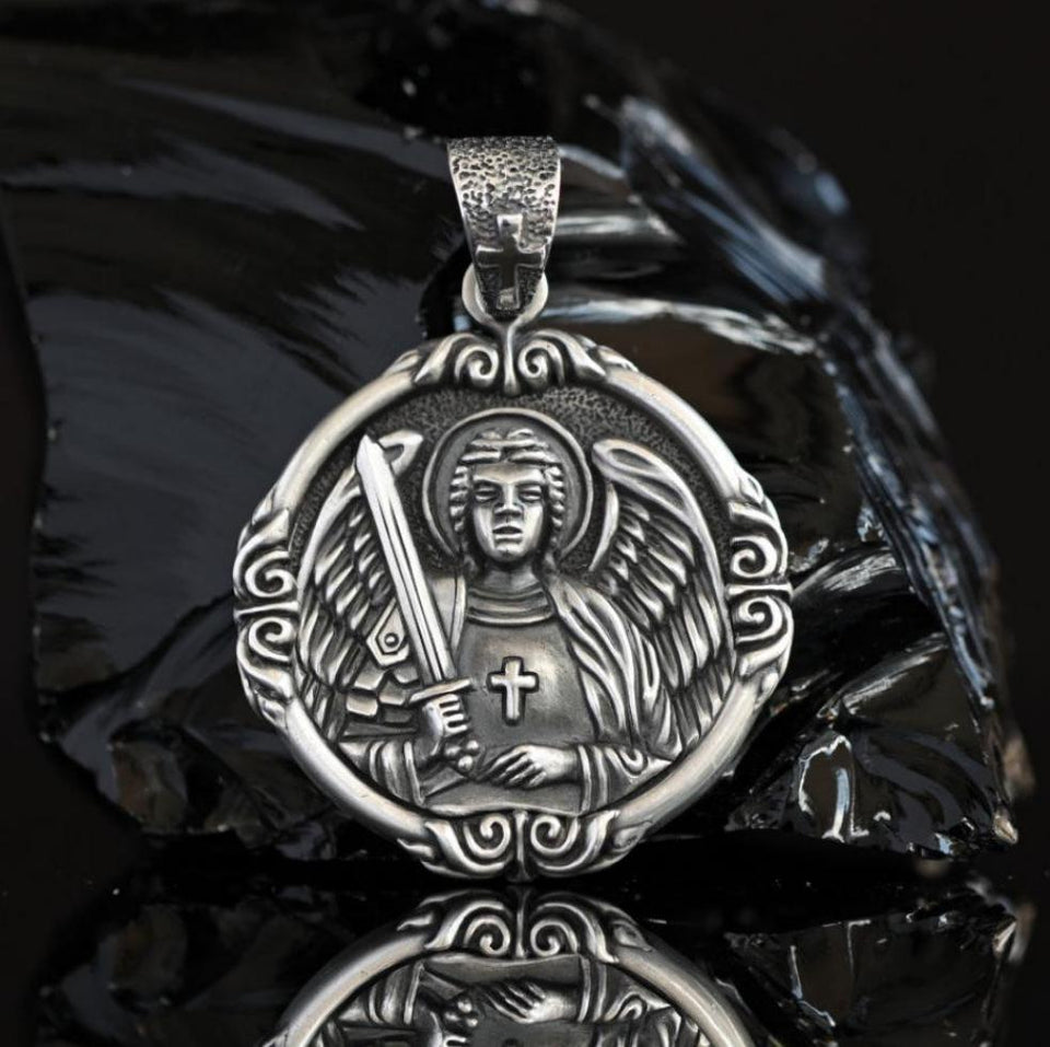 Sterling silver Archangel Michael pendant for men, detailed Catholic miraculous medal with sword and angel wings, handcrafted 925 silver protection medallion. Side view of solid 925 sterling silver Archangel Michael medal, showing intricate engraved details of angel and sword, large men’s religious pendant handmade