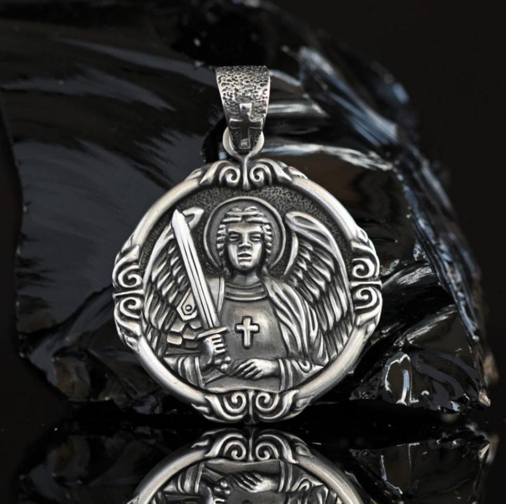 Sterling silver Archangel Michael pendant for men, detailed Catholic miraculous medal with sword and angel wings, handcrafted 925 silver protection medallion. Side view of solid 925 sterling silver Archangel Michael medal, showing intricate engraved details of angel and sword, large men’s religious pendant handmade